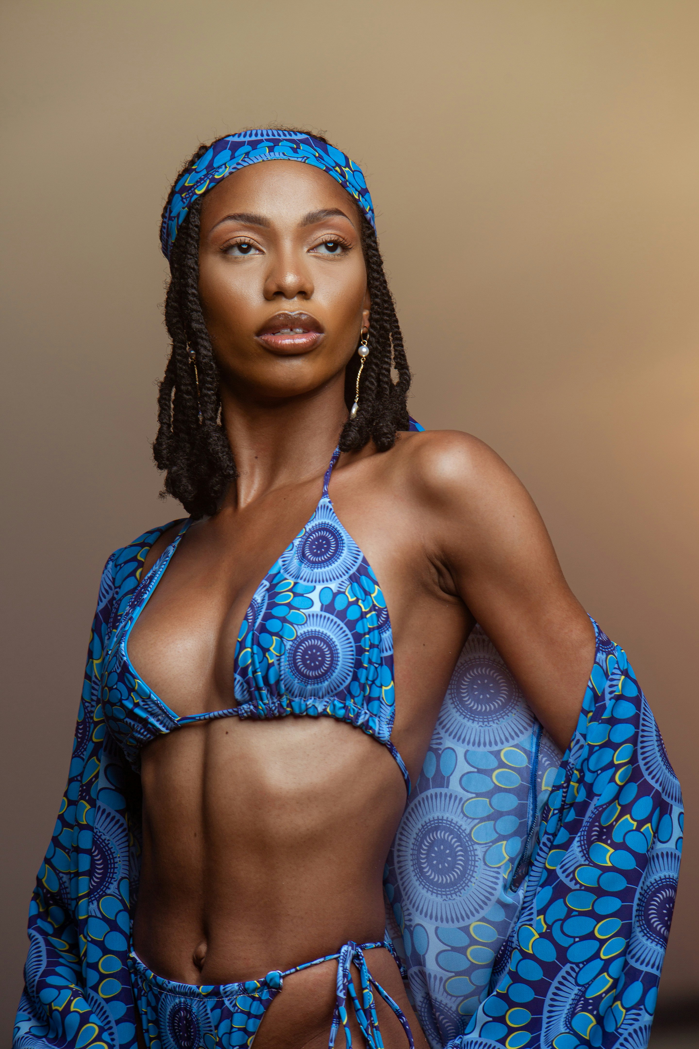 a woman in a blue bikini top and skirt