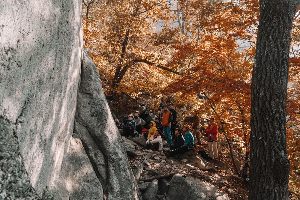 a group of people standing on top of a rocky hillside