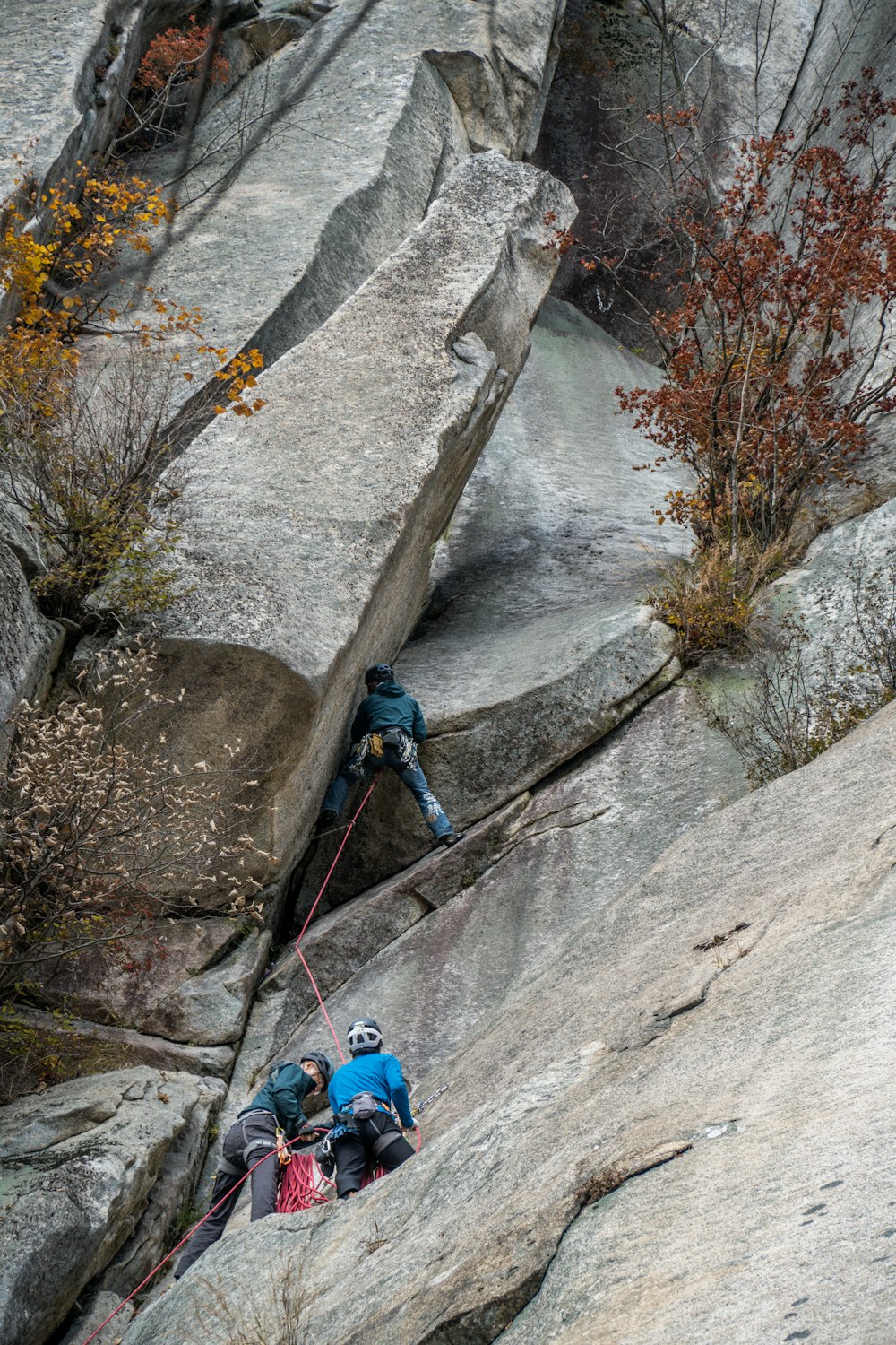 a man climbing up the side of a mountain