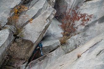 a man climbing up the side of a mountain