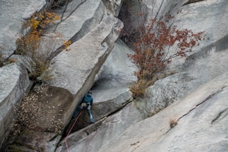 a man climbing up the side of a mountain