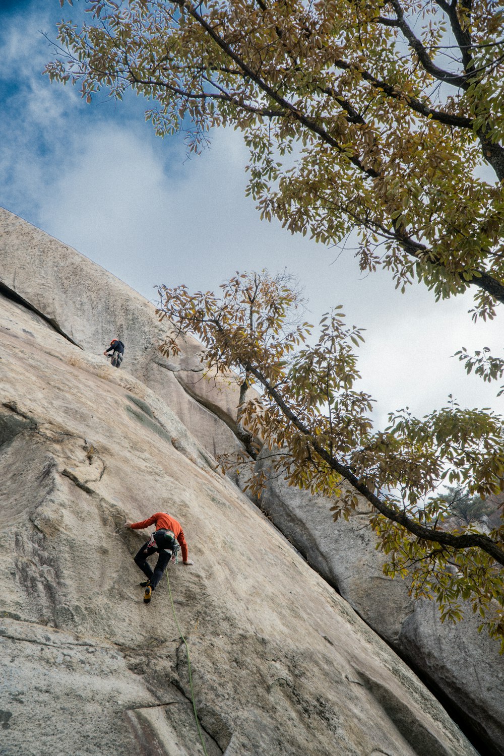 a man climbing up the side of a mountain