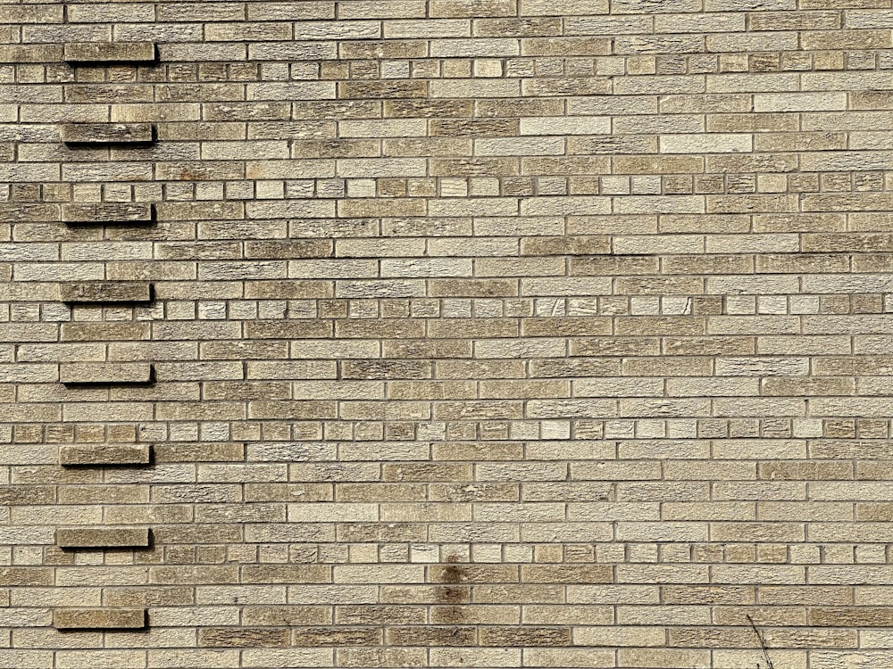 a brick wall with a clock on the side of it