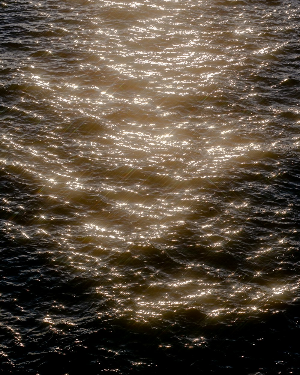 a large body of water with a boat in the distance