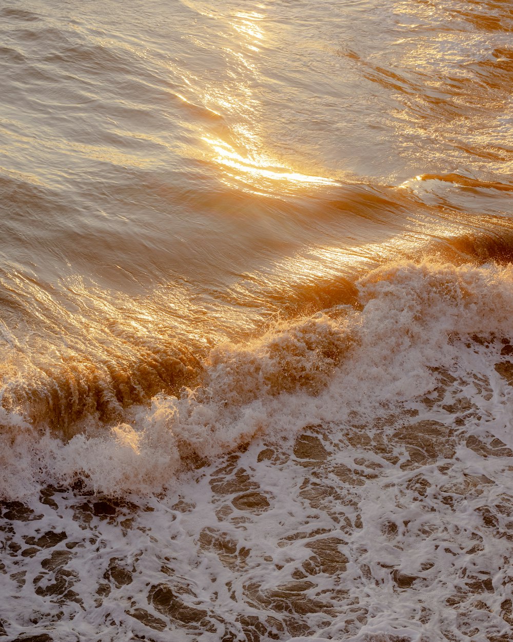 a person riding a surfboard on top of a wave