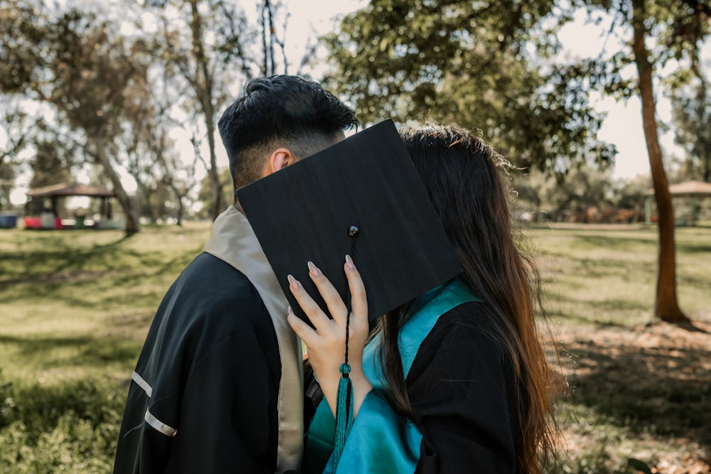 a man and a woman hugging in a park