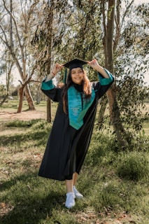a woman in a graduation gown posing for a picture