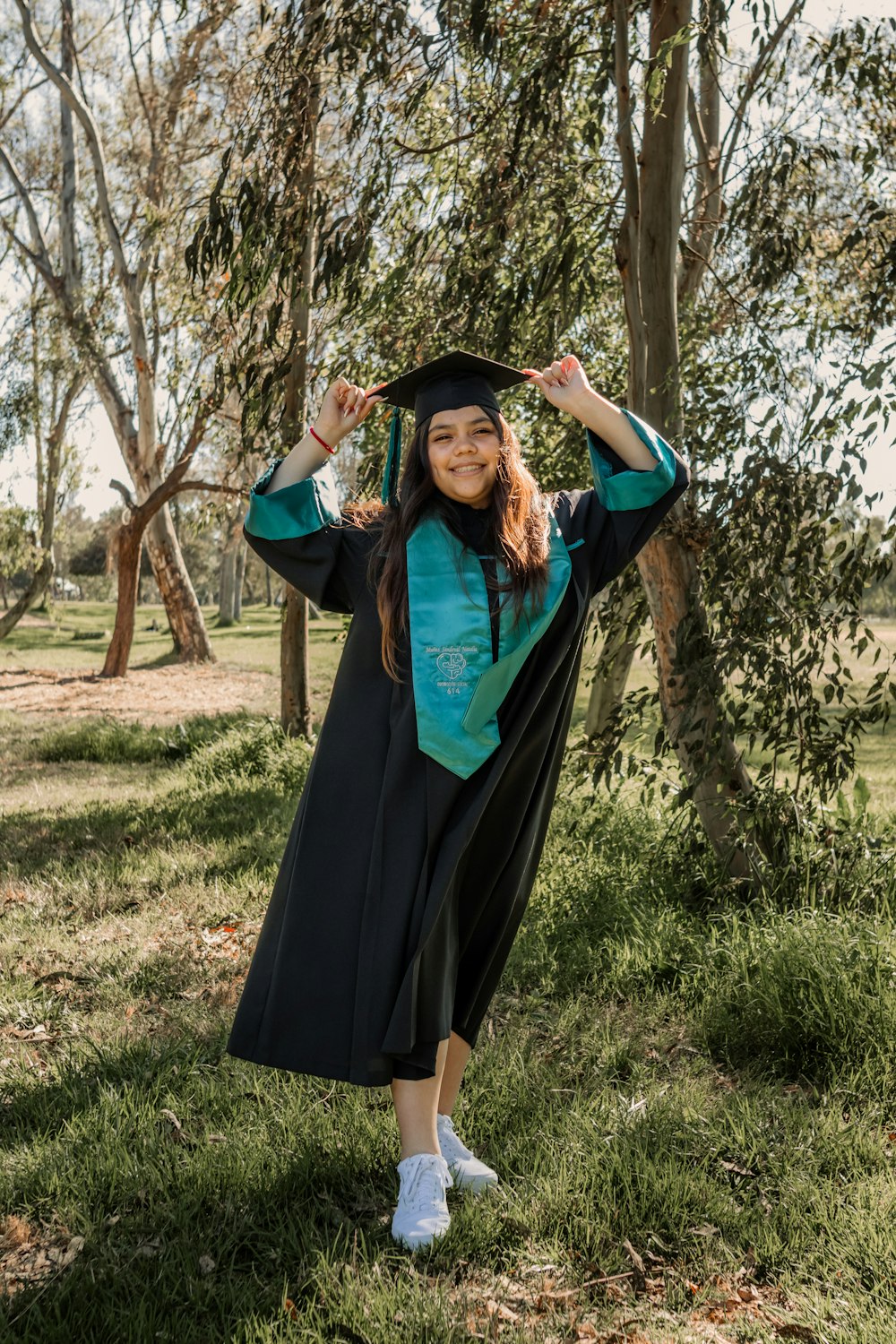 a woman in a graduation gown posing for a picture