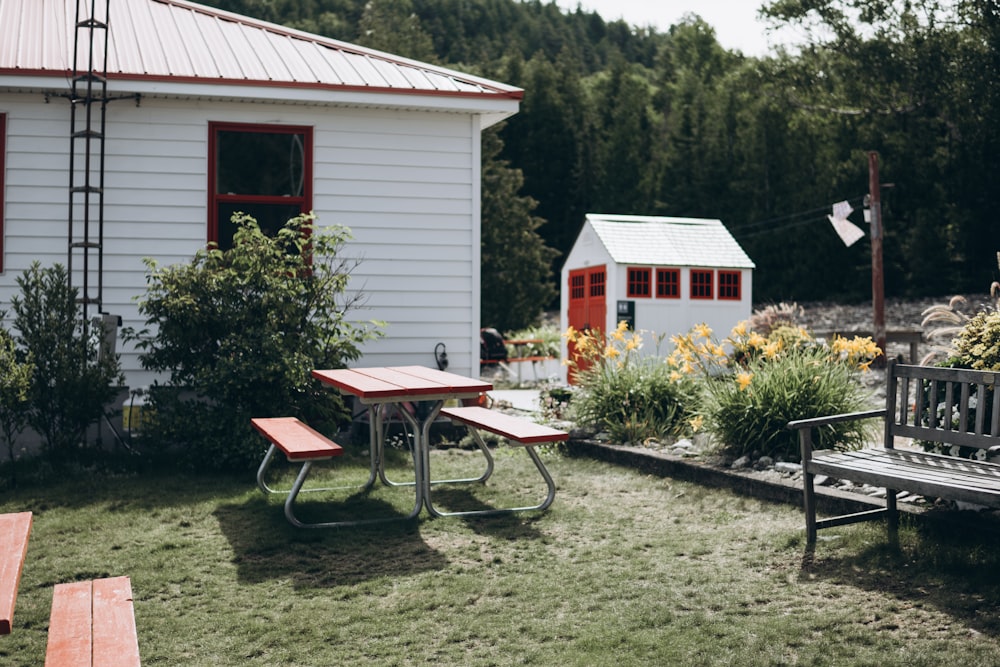 a wooden bench sitting next to a white house