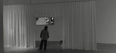 Author signing copies at a refined, minimalist book launch event.