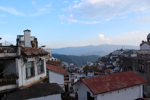 A scenic view of a traditional Portuguese village with whitewashed houses and vibrant flowers.