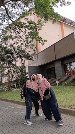 Smiling family posing near the Masjid al-Haram with the cityscape in the background