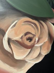 Close-up of a renaissance-inspired artwork with modern graphic overlays in cream and beige tones.