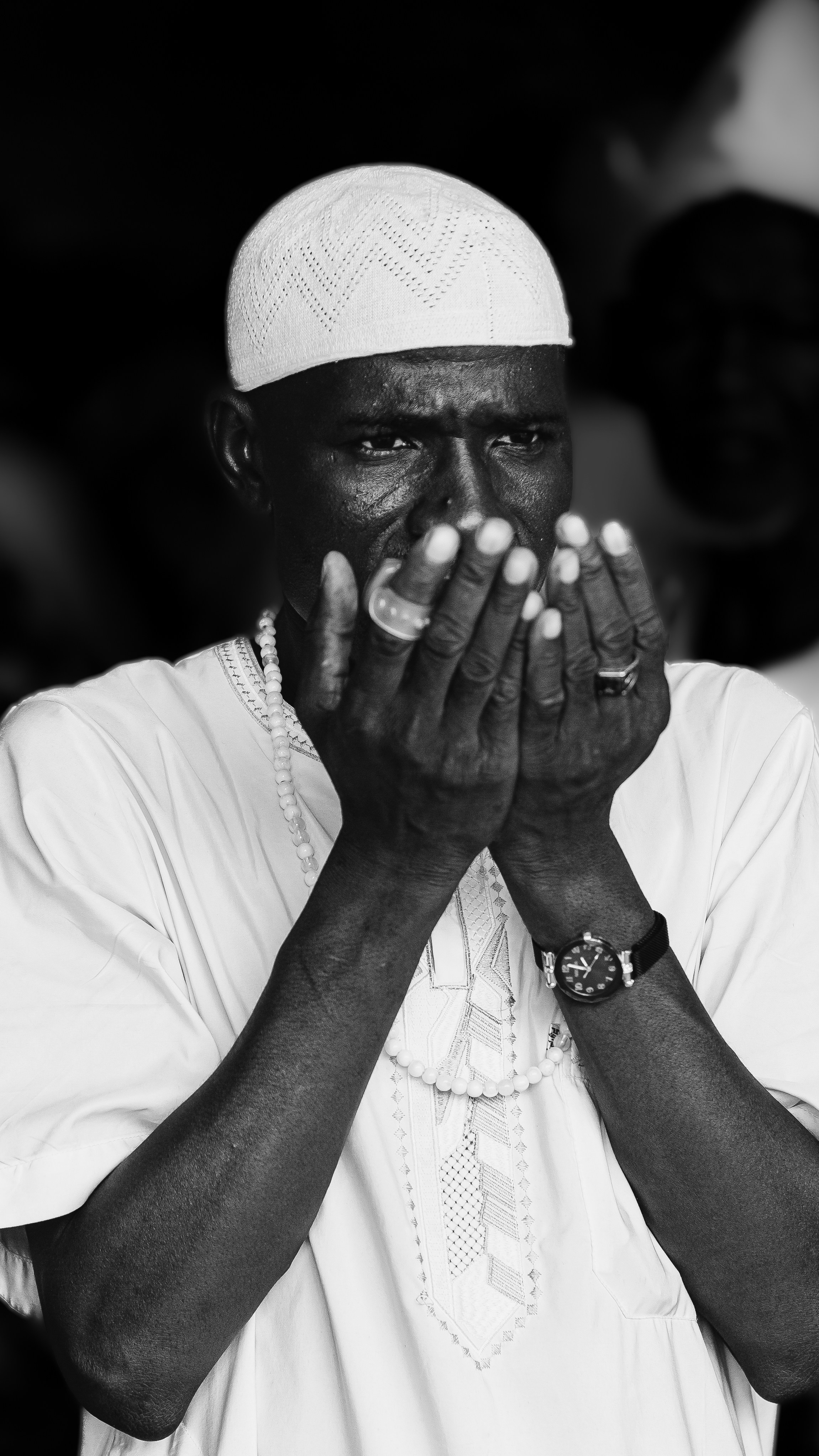 a black and white photo of a man praying