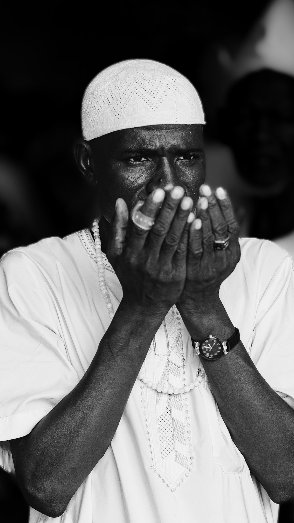 a black and white photo of a man praying