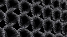 Interwoven strands of dark, metallic wires form a textured, lattice-like pattern. The intricate braiding creates a sense of depth and complexity, with highlights emphasizing the reflective surface of the materials.