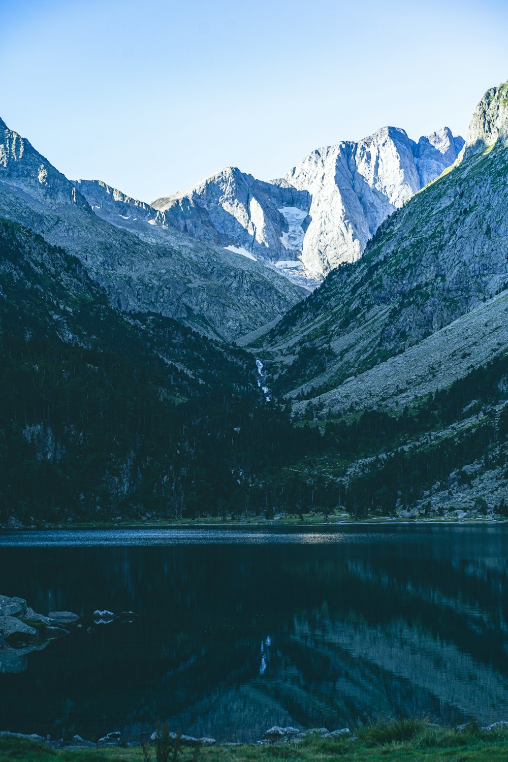 a mountain range with a lake in the foreground