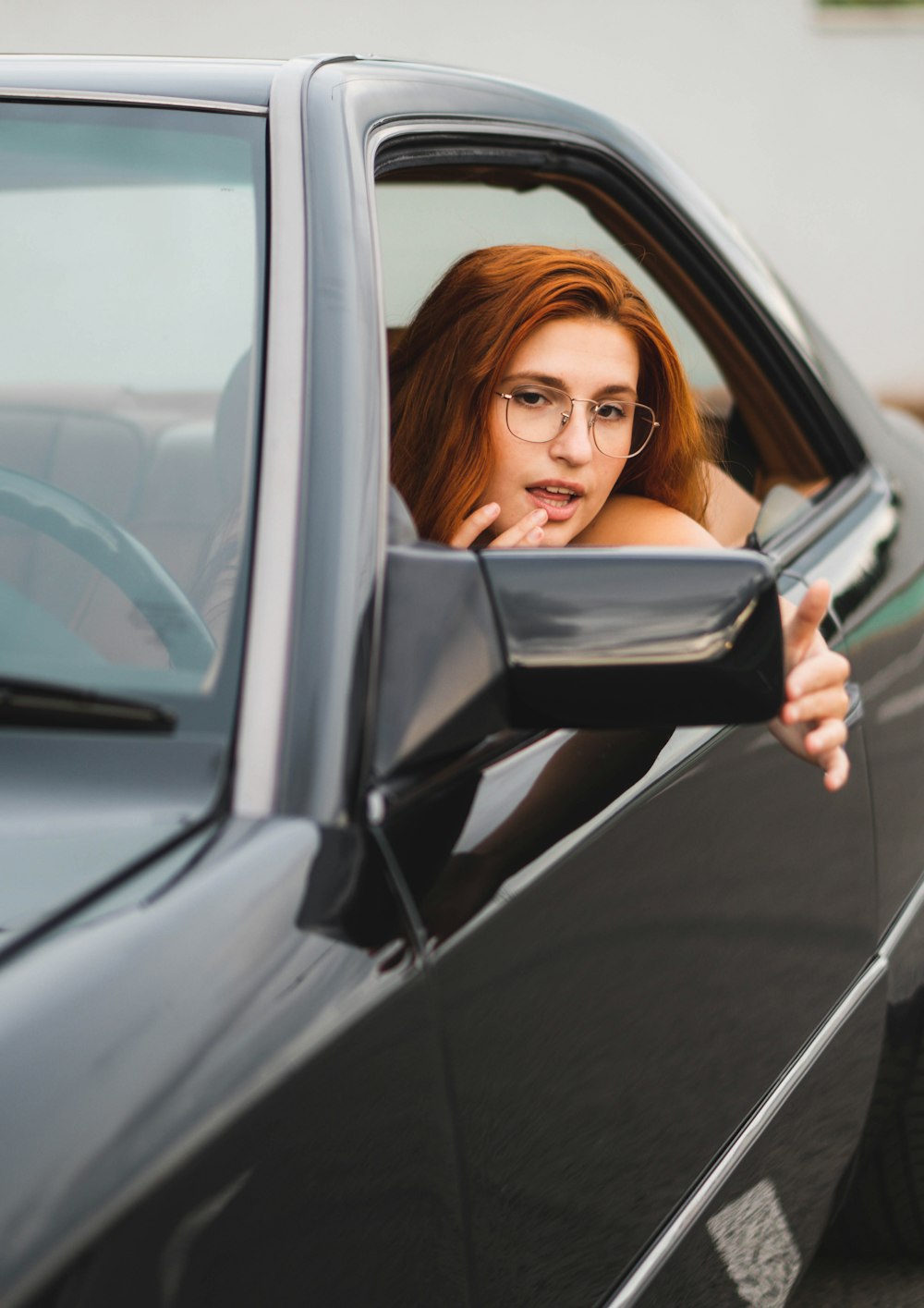 a woman in a car looking out the window