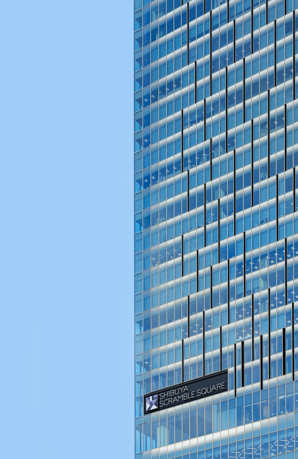 a tall building with a street sign in front of it