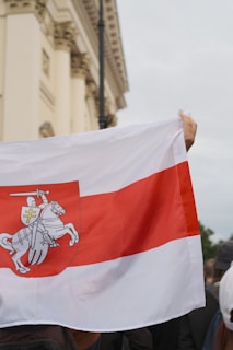 Sponsor emblem painted on a medieval-style flag fluttering in the wind.