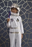 Children enjoying a space-themed birthday party with astronaut costumes and cosmic balloons.