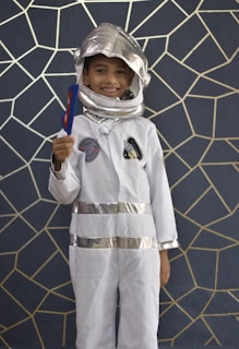 A space explorer party with starry decorations, astronaut costumes, and a rocket-shaped birthday cake