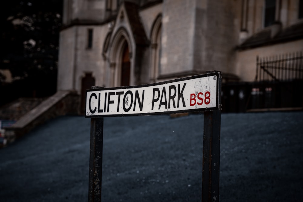 a street sign in front of a large building