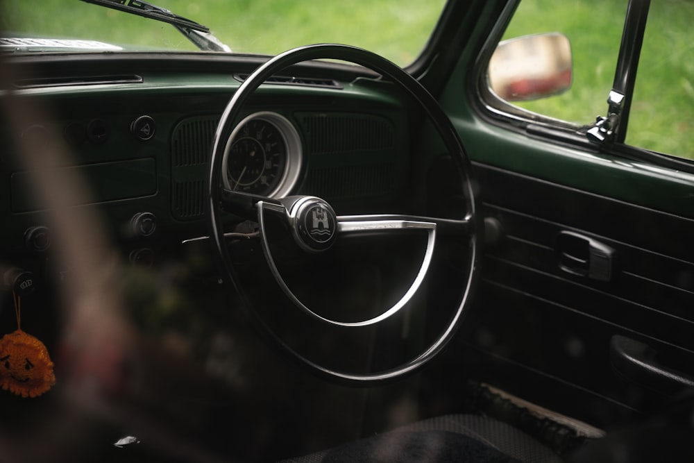 the interior of a car with a steering wheel and dashboard