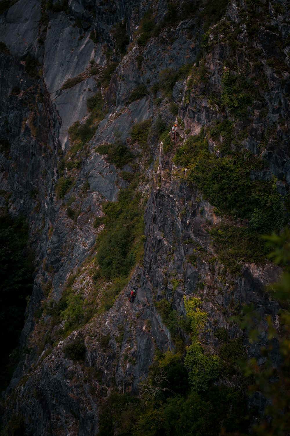 a person climbing up the side of a mountain