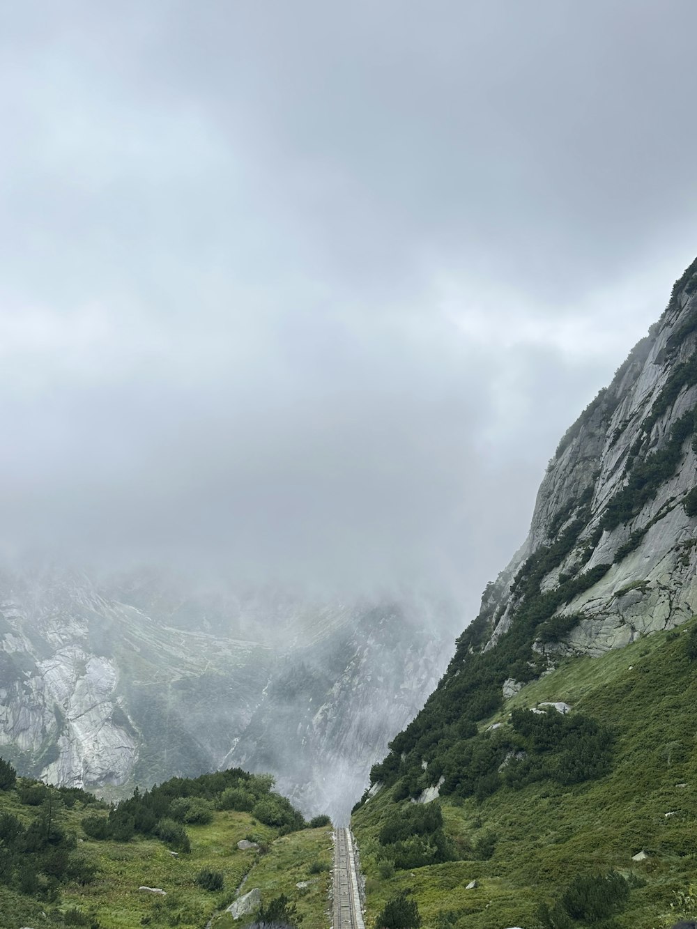 a long road with a mountain in the background