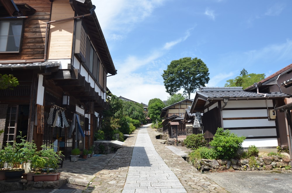 a cobblestone street lined with wooden buildings