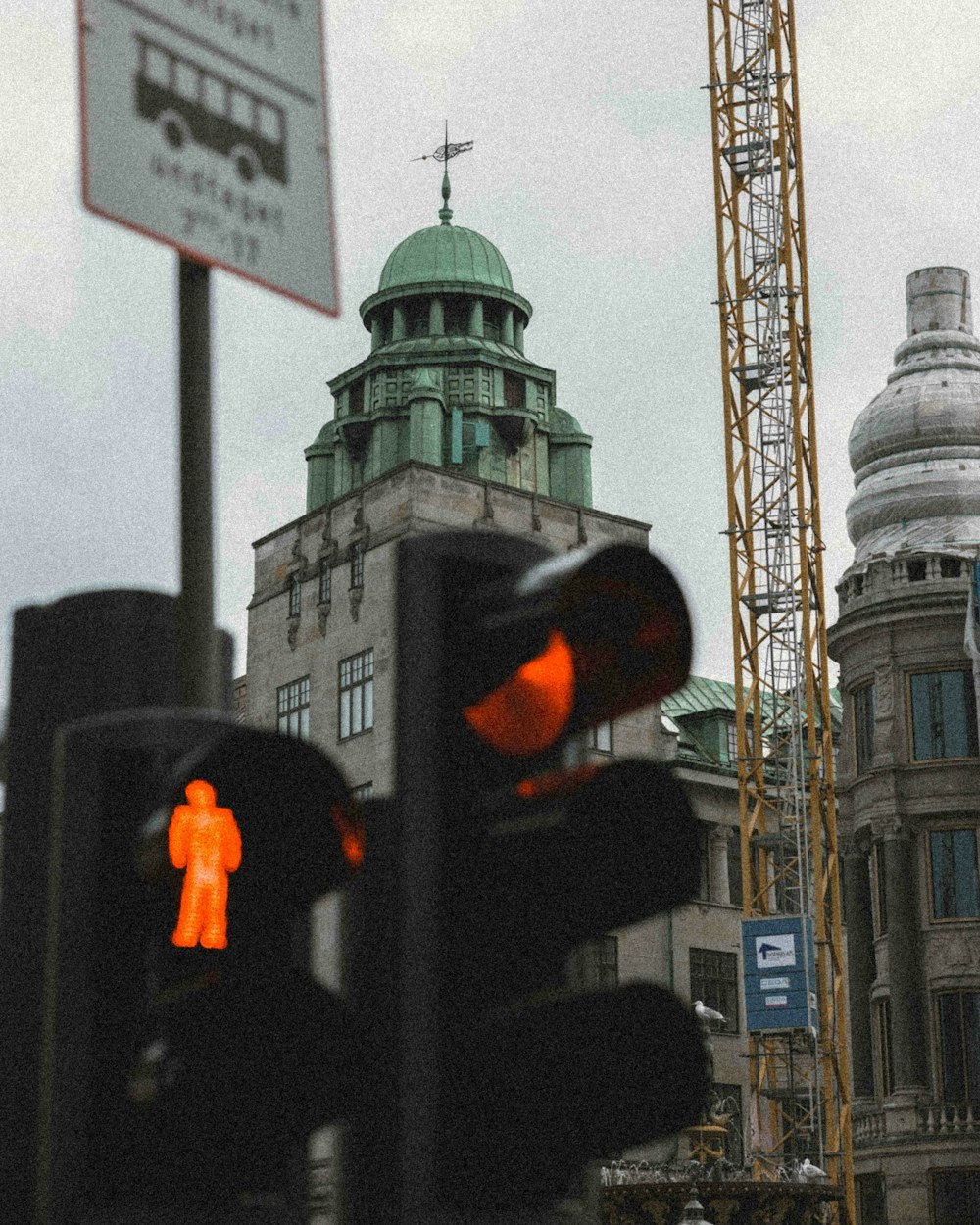 a traffic light with a building in the background