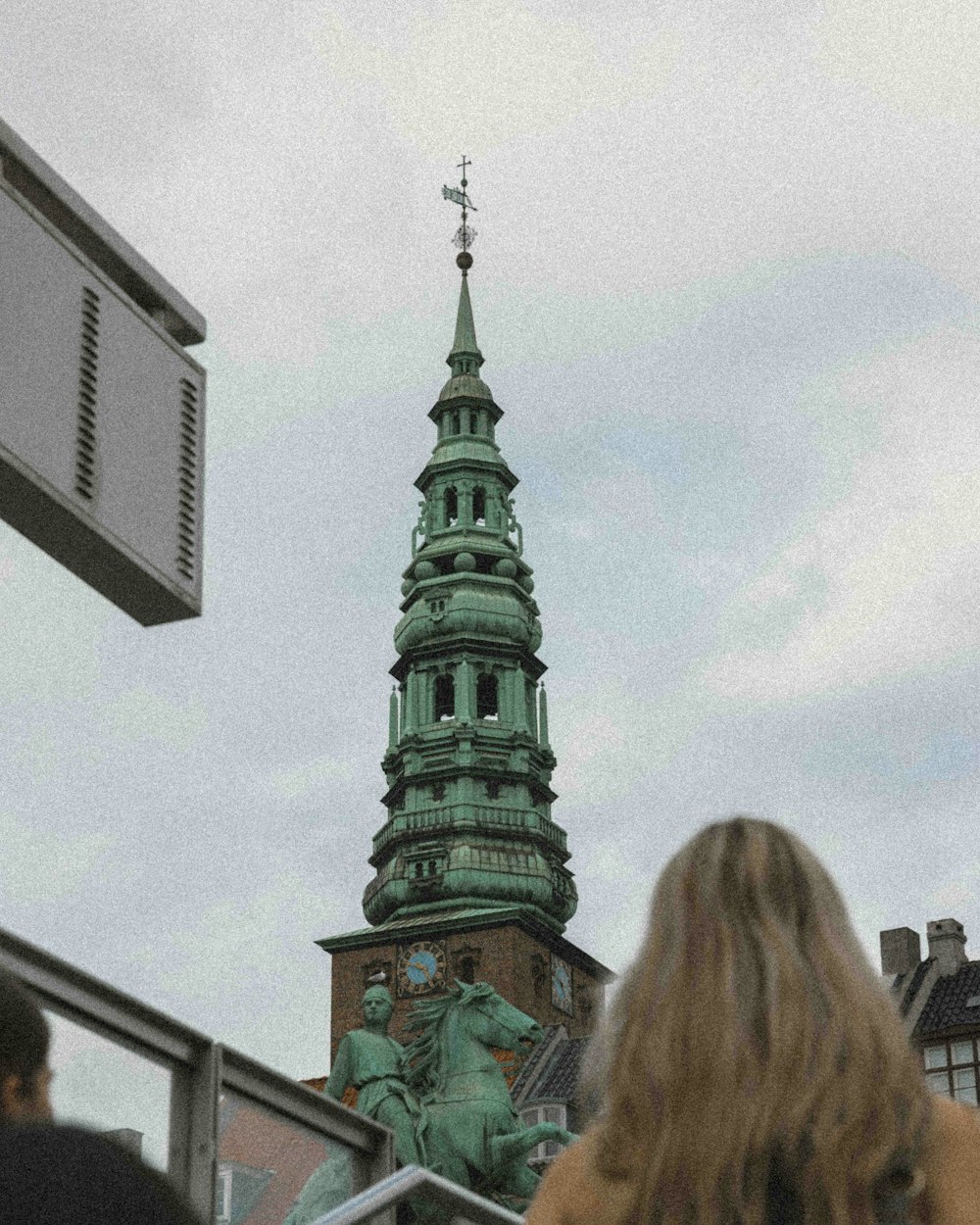 a woman standing in front of a tall building