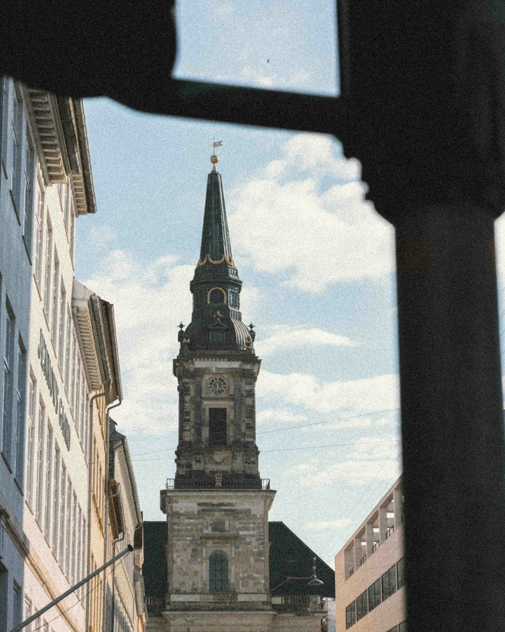 a tall clock tower towering over a city