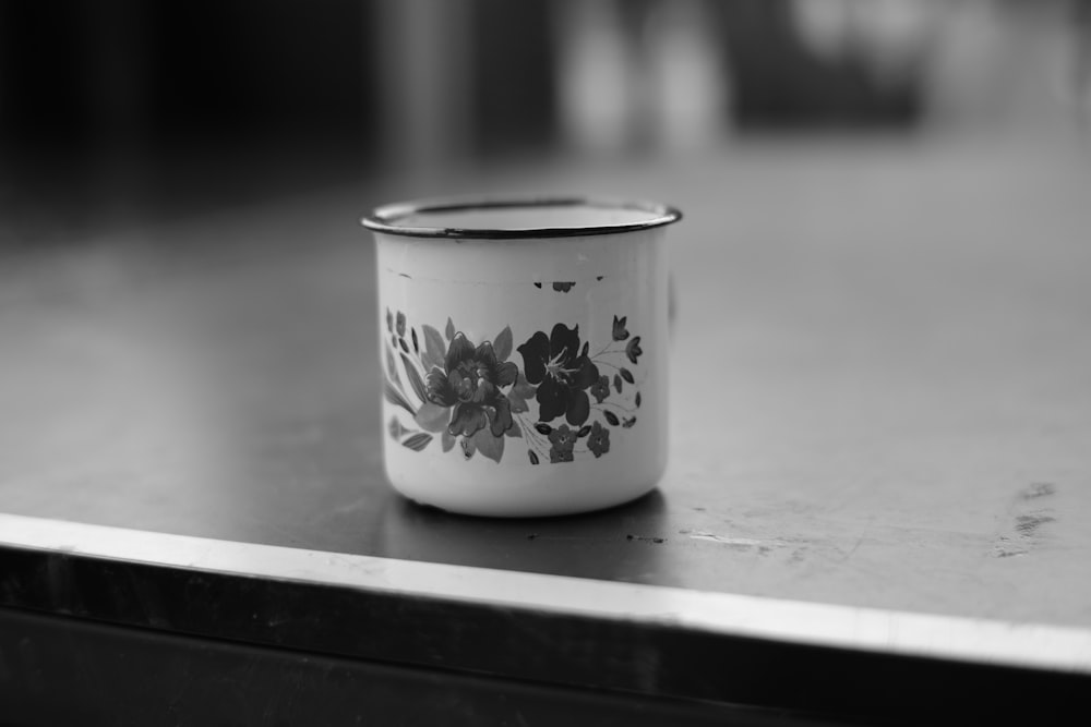 a black and white photo of a coffee cup