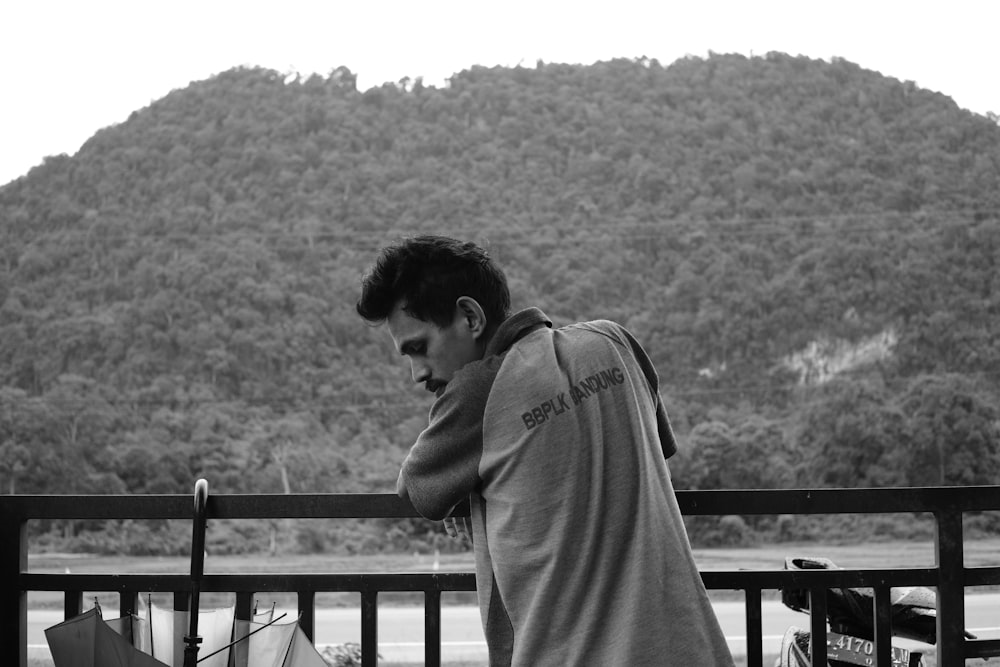 a man sitting on a bench next to a mountain