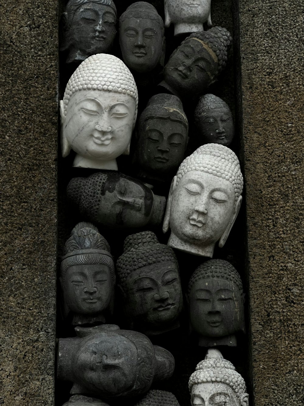 a bunch of buddha heads in a box