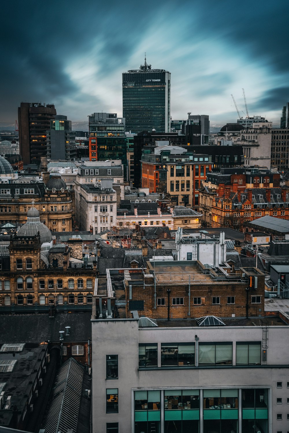 a view of a city with tall buildings and a cloudy sky