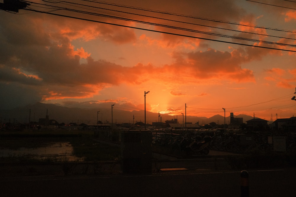 the sun is setting over a parking lot