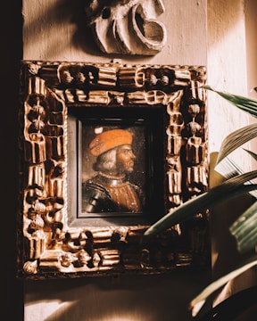 Close-up of a richly detailed oil painting showing a serene Renaissance-style portrait.