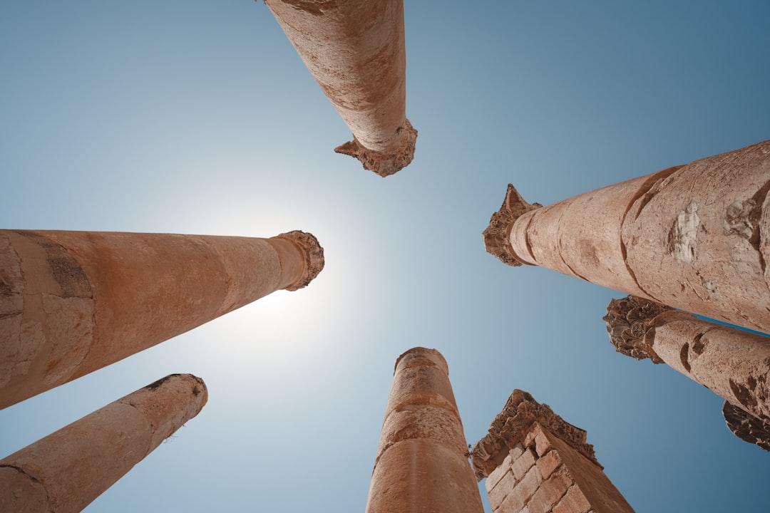 looking up at a group of tall stone pillars,