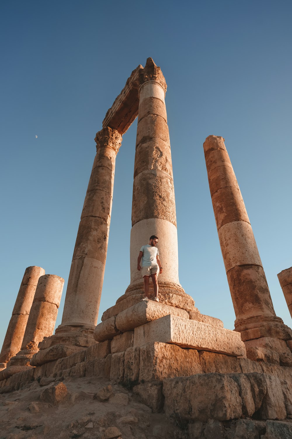 a man standing on top of a stone structure