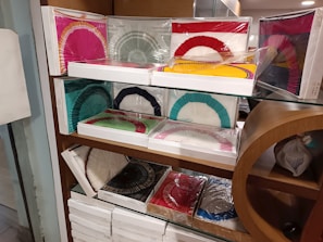 Stack of vibrant, handmade Ivorian fans ready for fast delivery