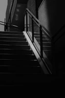 High-contrast shot of a sleek, modern staircase under construction with sharp lines.