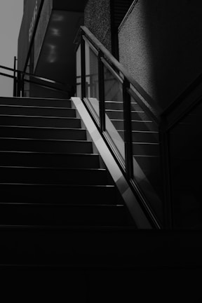 Close-up of a sleek staircase with sharp angles and subtle shadows emphasizing its form.