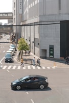 A city street with a Flexmove car waiting at a busy intersection.