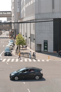 A city street with a Flexmove car waiting at a busy intersection.