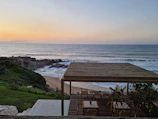 Sunset view from a terrace overlooking the turquoise sea.