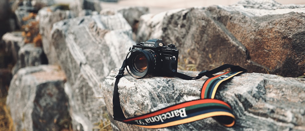 a camera sitting on top of a rock