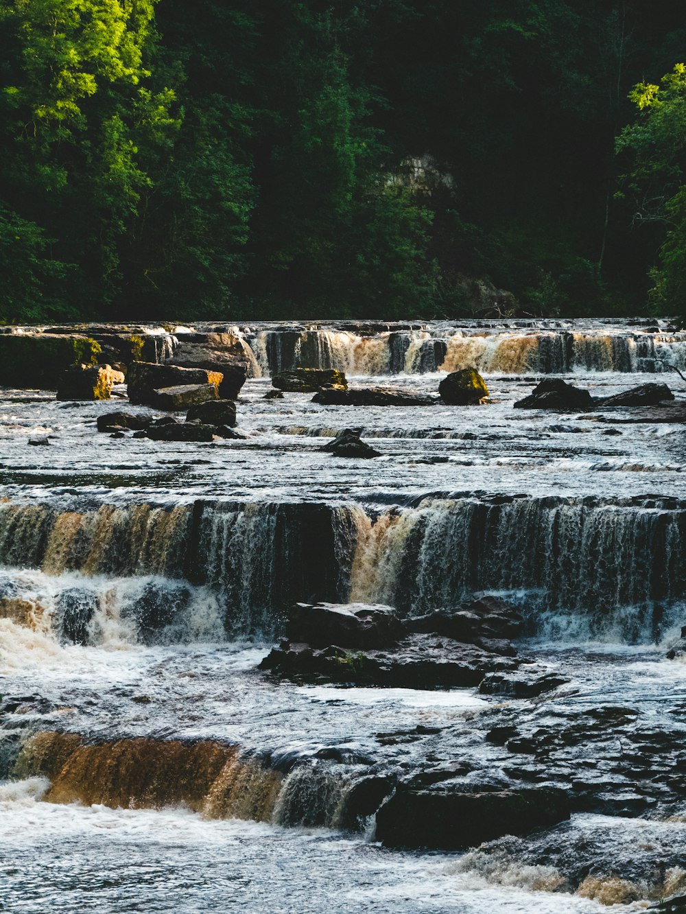 a man standing on the edge of a waterfall